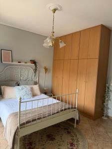 a bedroom with a bed with a wooden cabinet at The Stay in Igoumenitsa