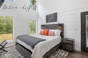 a bedroom with a bed with a wooden headboard at Escape to Tranquility - Hot Tub - BBQ - Pets in Broken Bow