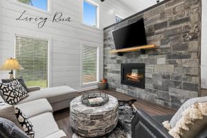 a living room with a couch and a fireplace at Escape to Tranquility - Hot Tub - BBQ - Pets in Broken Bow