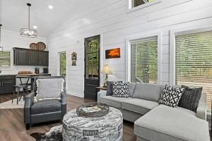 a living room with a couch and a table at Escape to Tranquility - Hot Tub - BBQ - Pets in Broken Bow
