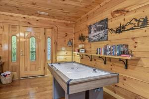 a kitchen with a stove in a log cabin at Chasing Cubs Cabin by Beyond Expectations in Sevierville
