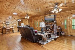 a living room with a couch and a table at Chasing Cubs Cabin by Beyond Expectations in Sevierville +45 photos