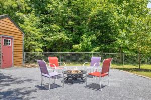 a group of chairs around a table with a fire pit at Chasing Cubs Cabin by Beyond Expectations in Sevierville