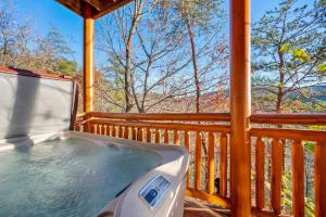 a hot tub on the deck of a cabin at Paradise Pointe Pool Lodge by Beyond Expectations in Sevierville