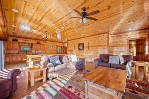 a living room with couches and a ceiling fan at Paradise Pointe Pool Lodge by Beyond Expectations in Sevierville +61 photos