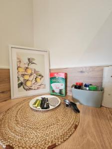 a table with a plate and a picture and a knife at L'Entre Deux Gare Centre-Ville in Saint-Brieuc