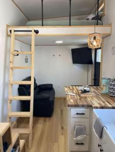 a room with a bunk bed and a desk at Mountain Top Tiny House by Beyond Expectations in Waldens Creek