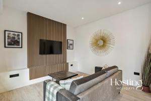 a living room with a couch and a flat screen tv at Platform One Apartments - Caversham in Reading