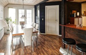 a kitchen and dining room with a table and chairs at Apartment Sønderskovhedevej in Langå