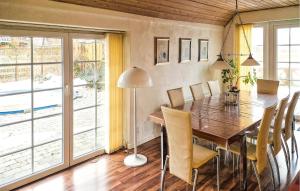 a dining room with a wooden table and chairs at Apartment Sønderskovhedevej in Langå
