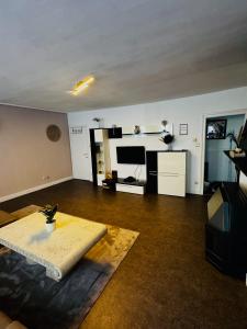 a living room with a couch and a table at Appartement De panne in De Panne