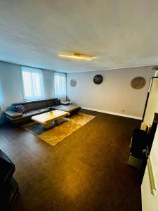 a living room with a couch and a coffee table at Appartement De panne in De Panne