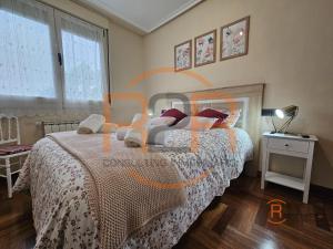 a bedroom with a bed with a comforter on it at R2R - El Raitán - 1A122 in Gijón