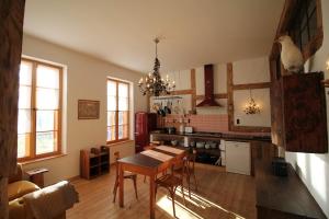 a kitchen with a table and a dining room at Die Orchidee - Gutshaus Bückling in Rambin