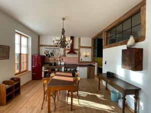 a kitchen with a table and a dining room at Die Orchidee - Gutshaus Bückling in Rambin