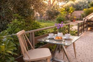 a table with a bowl of fruit and a cup of coffee at Aioliana Apartments in Mytilene +6 photos