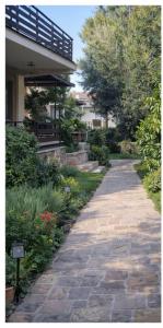 a stone walkway in front of a building at Aioliana Apartments in Mytilene