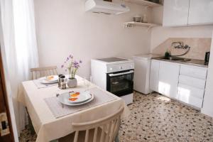 a small kitchen with a table with plates on it at Aioliana Apartments in Mytilene