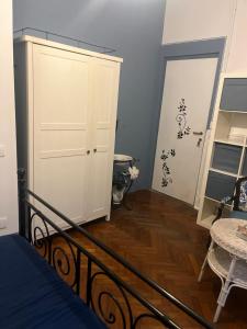 a bedroom with a bed and a closet and a door at Casa Ortensia Blu in Maslianico +127 photos