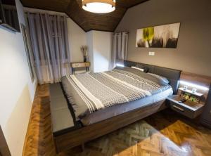 a bedroom with a large bed in a room at Belajec Wine & Nature Retreat in Veliko Brdo