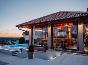 a house with a patio and a swimming pool at Belajec Wine & Nature Retreat in Veliko Brdo