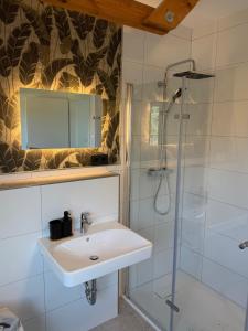 a bathroom with a sink and a shower at Pension Holter Deel in Cuxhaven +60 photos