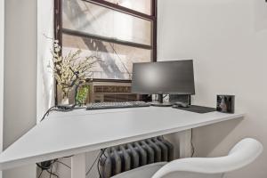 a desk with a computer and a window at Chic Times Square 1-Bedroom Apartment - Hosts 4 in New York
