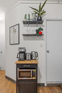 a kitchen with a counter with a microwave on it at Chic Times Square 1-Bedroom Apartment - Hosts 4 in New York