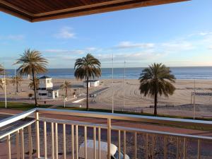 a balcony with a view of the beach and the ocean at Primera línea Playa Gandia in Gandía