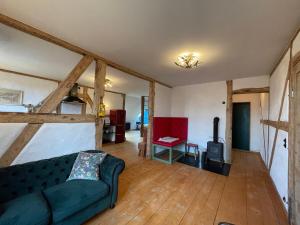 a living room with a couch and a stove at Die Perle - Gutshaus Bückling in Rambin