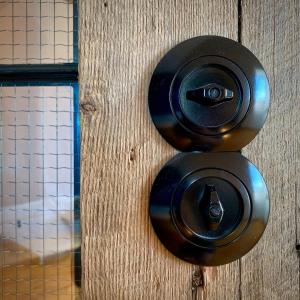 a wooden door with two black door knobs on it at Die Perle - Gutshaus Bückling in Rambin +18 photos