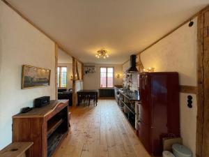 a kitchen with a refrigerator and a table in it at Die Perle - Gutshaus Bückling in Rambin