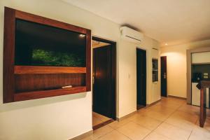 a room with a large window on the wall at Hotel Tré Iguazú in Puerto Iguazú