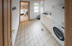 a kitchen with a washing machine and a sink at Nice Home In Oksbøl With Sauna in Oksbøl +8 photos