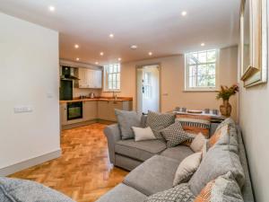 a living room with two couches and a kitchen at Broadmoor Chapel in Hereford