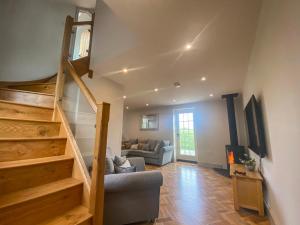 a living room with a staircase and a couch at Broadmoor Chapel in Hereford