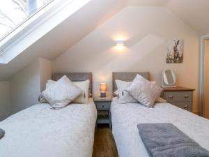 two beds in a room with a attic at Broadmoor Chapel in Hereford