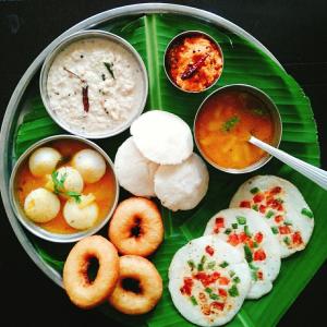 a plate of food on a banana leaf at Monsoon Retreats by DAAN in Thekkady