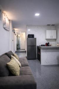 a living room with a couch and a kitchen at Peruyork Arbnb - Calle España in Chiclayo +5 photos