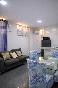 a living room with a couch and a glass table at Peruyork Arbnb - Calle España in Chiclayo