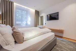 a bedroom with a large bed and a television at Appartament Seceda in San Sigismondo
