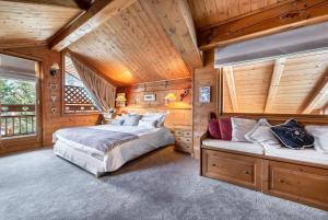 a bedroom with two beds in a wooden cabin at Chalet Les Solans in Les Allues