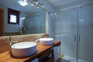a bathroom with a sink and a glass shower at Casa Rural O Fraginal in Guasillo +11 photos