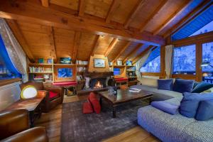 a living room with a couch and a fireplace at Chalet Les Solans in Les Allues