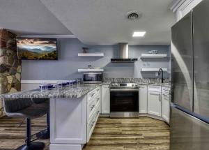 a kitchen with white cabinets and a counter top at 1023 English Mtn Condo by Beyond Expectations in Sevierville +31 photos
