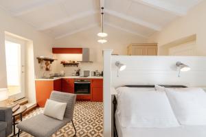 a bedroom with a bed and a kitchen at Kamari Guest House Corfu in Corfu International Airport I Kapodistrias