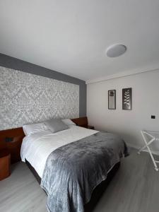 a bedroom with a large bed and a wall at VUT La CEPEDA in Astorga