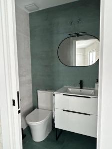 a bathroom with a toilet and a sink and a mirror at VUT La CEPEDA in Astorga +5 photos