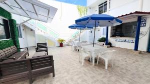 a patio with tables and chairs and umbrellas at HOTEL PARAISO ACAPULCO in Acapulco