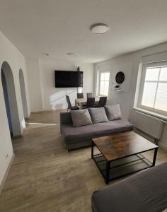 a living room with a couch and a table at Ferienwohnung NR3 in Großräschen